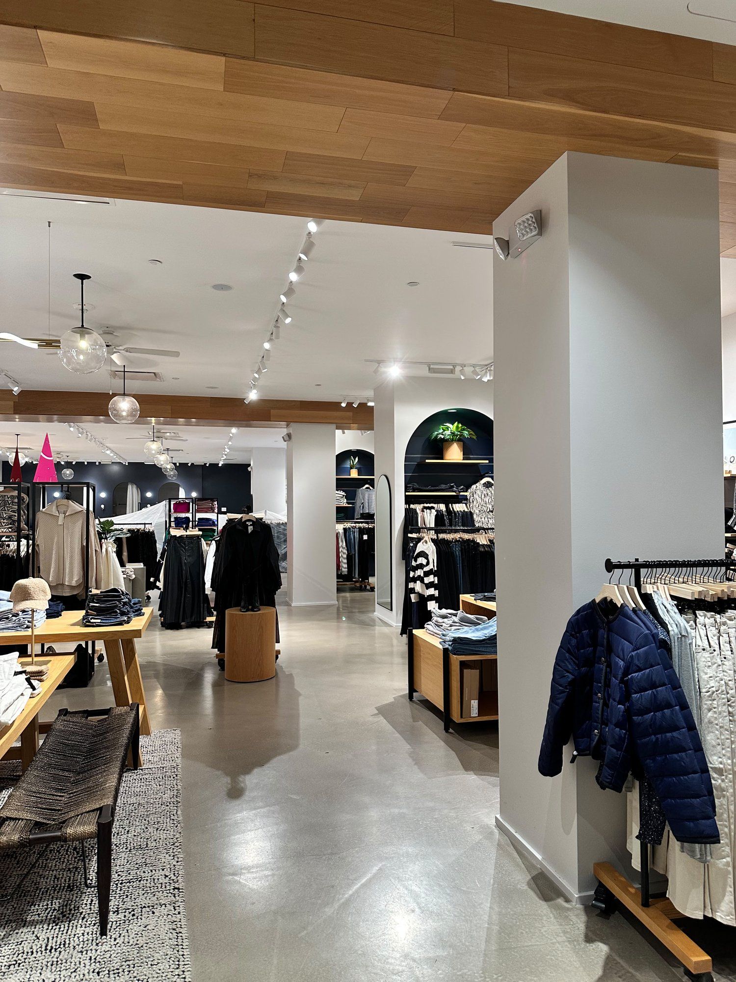 Spotless retail store with gleaming polished concrete floors between clothing displays