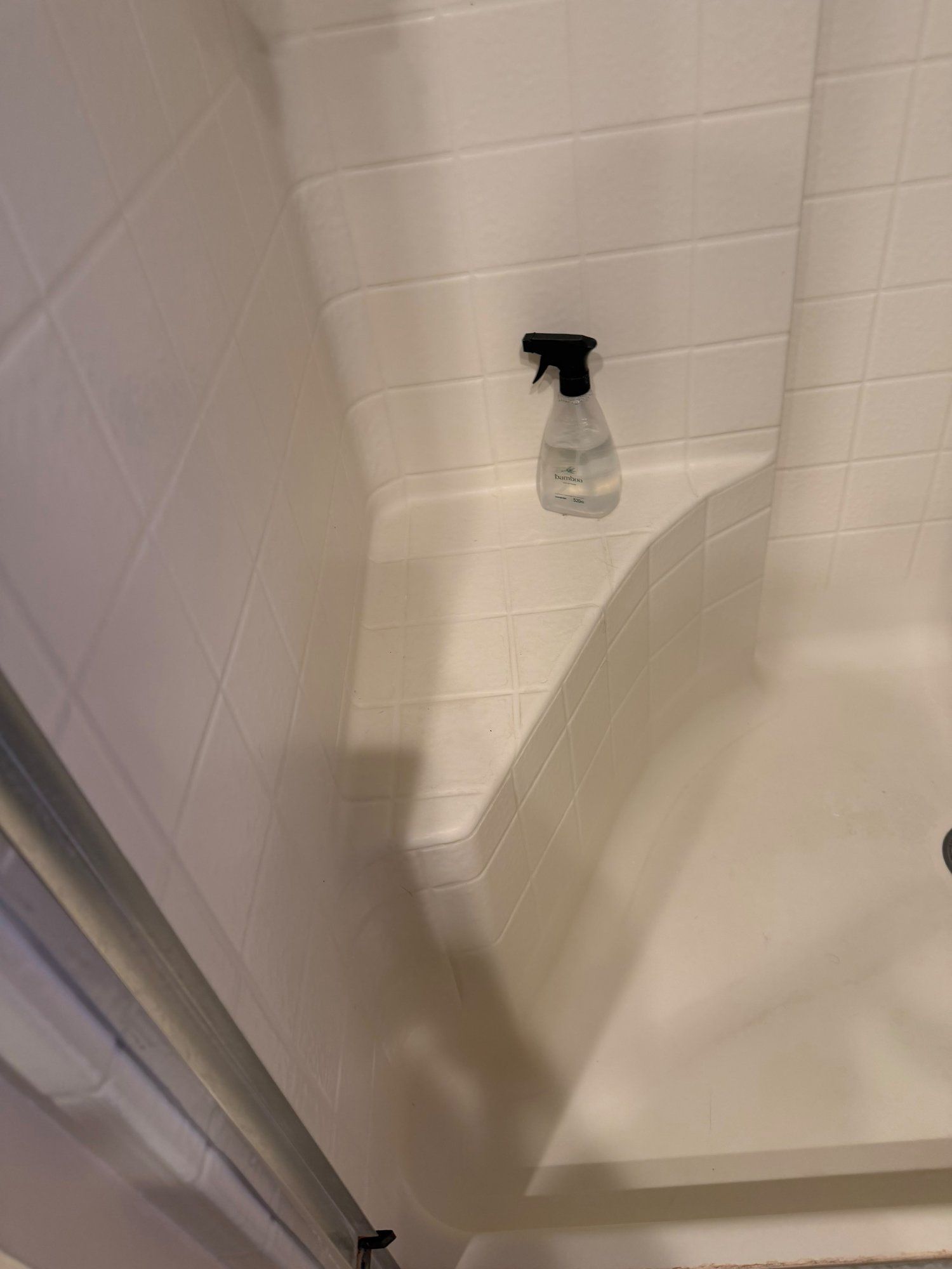 Spotless white shower stall after deep cleaning